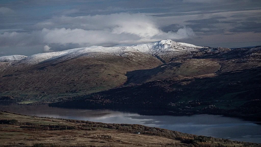 Snow-capped Ben Lawers above Loch Tay under a moody sky